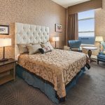 Lakeside Deluxe King | Larger than our standard rooms, these rooms feature one king size bed, a seating area that has lounge chairs and a table, as well as a window that overlooks Lake Superior.