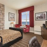 Lakeside Luxury King | These lakeside rooms feature one King size bed, a seating area two lounge chairs and table, and a spectacular view of Lake Superior.